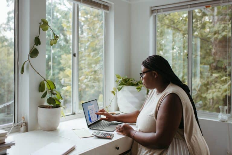 woman on laptop with plants